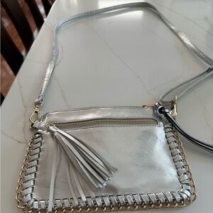 Silver Leather crossbody bag with gold chain-link trim.